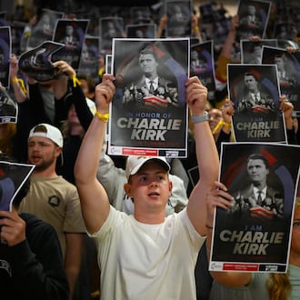People hold posters of Charlie Kirk during a Turning Point USA rally at Utah State University, as a part of the organization's push to memorialize Kirk on Tuesday, Sept. 30, 2025, in Logan, Utah. (Alex Goodlett/AP)