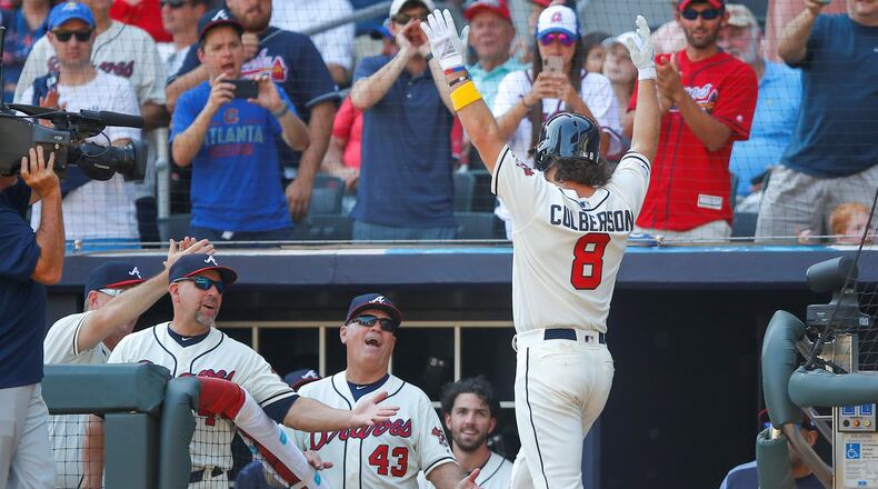 Charlie Culberson #8 of the Atlanta Braves celebrates with manager Brian Snitker after hitting a home run in the ninth inning of an MLB game against the Washington Nationals at SunTrust Park on September 8, 2019 in Atlanta, Georgia. (Photo by Todd Kirkland/Getty Images)