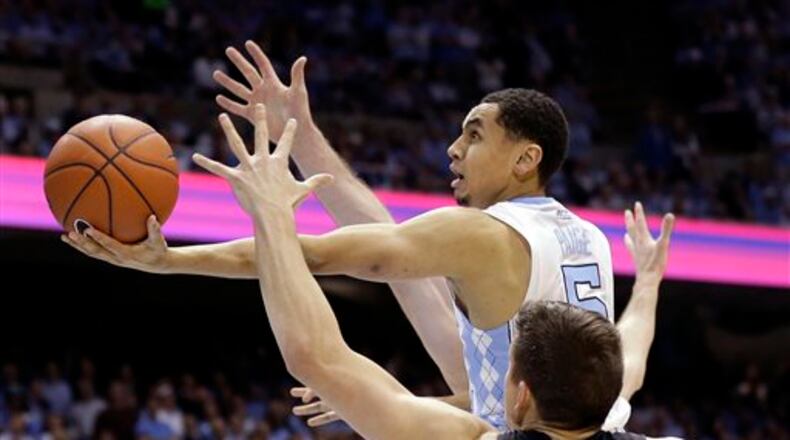 FILE - In this Feb. 17, 2016, file photo, North Carolina's Marcus Paige (5) drives to the basket as Duke's Grayson Allen (3) defends during the first half of an NCAA college basketball game in Chapel Hill, N.C. The NBA is loaded with top-tier point guards and talented players at the position will get good looks during Summer League play. And though there are about 90 roster spots for point guards in the NBA, a strong pedigree is no longer enough as players like Paige, a McDonalds All-American that led North Carolina to the national championship game, face an uphill climb for a roster spot. (AP Photo/Gerry Broome, File)