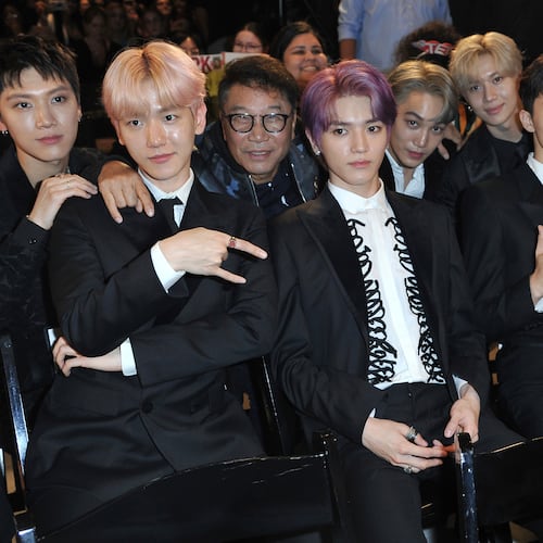 FILE - Producer Lee Soo Man, third from left, and members of SuperM, from left, Ten, Baekhyun, Taeyong, Kai, Taemin, Mark and Lucas sit in the audience to watch the premiere of their music video for their song "Jopping" during a media conference on Oct. 3, 2019, at Capitol Studios in Los Angeles. (Photo by Richard Shotwell/Invision/AP, File)