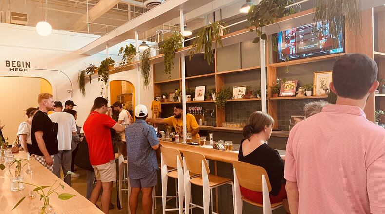 Elsewhere Brewing’s second location, called The Greenhouse, features a cozy atmosphere with house plants and vinyl records spinning behind the bar. 
(Bob Townsend for the Atlanta Journal Constitution)