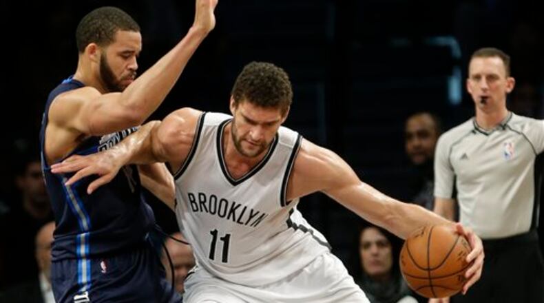Dallas Mavericks' JaVale McGee (11) defends against Brooklyn Nets' Brook Lopez (11) during the first half of an NBA basketball game Wednesday, Dec. 23, 2015, in New York. (AP Photo/Frank Franklin II)