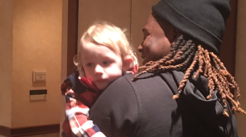 Shaquem Griffin, a linebacker for UCF, holds Jordan Davis on Wednesday. Griffin and Davis were each affected by Amniotic Band Syndrome before they were born.