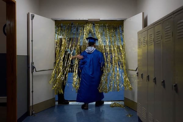 A student from the Galena Interior Learning Academy enters a gym during a graduation ceremony for the school Wednesday, May 21, 2025, in Galena, Alaska. (AP Photo/John Locher)