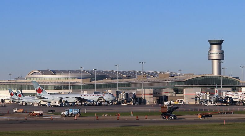 FILE PHOTO: A tarmac worker at Toronto's Pearson International Airport tried to cheer up a crying child on a flight by dancing.