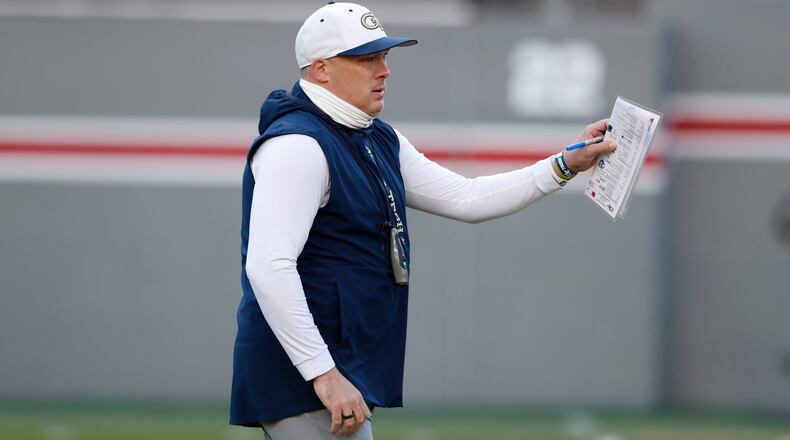 Georgia Tech head coach Geoff Collins watches his team warm up before facing N.C. State Saturday, Dec. 6, 2020, at Carter-Finley Stadium in Raleigh, N.C. (Ethan Hyman/The News & Observer)
