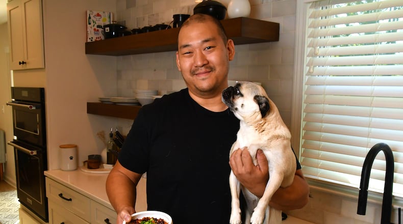 James Beard Award-nominated Brian So of Spring restaurant hangs out with one of his favorite pugs, Freddie. When So cooks for himself, his food leans toward Korean, the cuisine he grew up eating at home in Kennesaw. (CHRIS HUNT FOR THE ATLANTA JOURNAL-CONSTITUTION)
