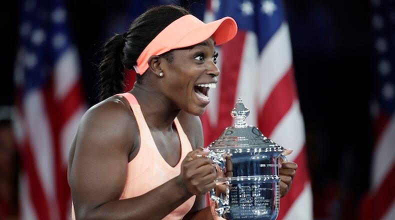 Sloane Stephens, of the United States, holds up the championship trophy after beating Madison Keys, of the United States, in the women's singles final of the U.S. Open tennis tournament, Saturday, Sept. 9, 2017, in New York. (AP Photo/Julio Cortez)