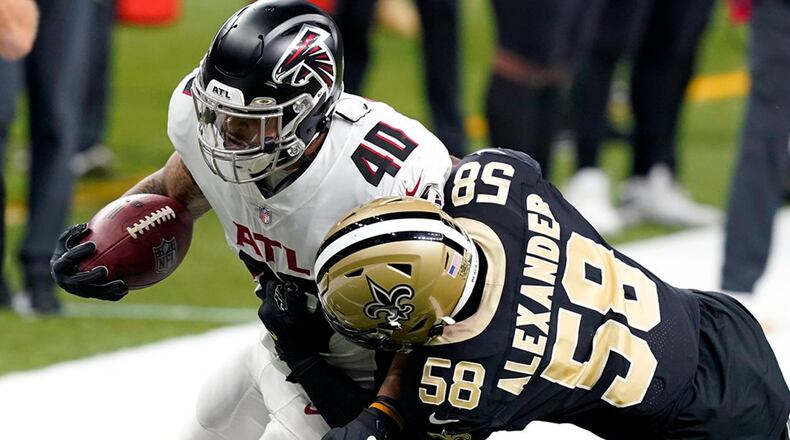Atlanta Falcons fullback Keith Smith (40) carries against New Orleans Saints outside linebacker Kwon Alexander (58) in the first half Sunday, Nov. 22, 2020, in New Orleans. (Butch Dill/AP)