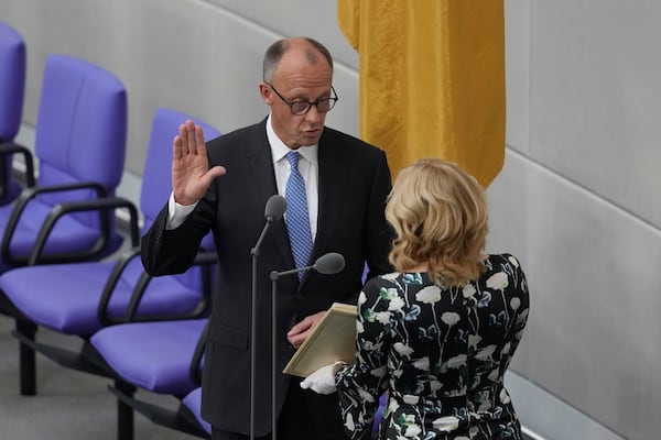 Friedrich Merz takes the oath of office in front of Parliament President Julia Kloeckner after being elected new Chancellor at the German federal parliament, Bundestag, at the Reichstag building in Berlin, Germany, Tuesday, May 6, 2025. (AP Photo/Markus Schreiber)