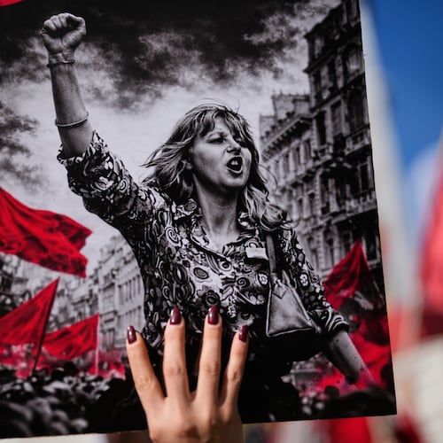 A woman holds up a placard during a protest marking the International Women's Day, in Istanbul, Turkey, Sunday, March 8, 2026. (AP Photo/Khalil Hamra)