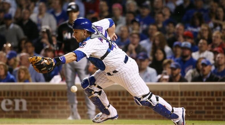 Chicago Cubs catcher Miguel Montero cannot catch the throw to home plate, resulting in a run by the Miami Marlins' Dee Gordon, not pictured, in the seventh inning at Wrigley Field in Chicago on Wednesday, June 7, 2017. (John J. Kim/Chicago Tribune/TNS)