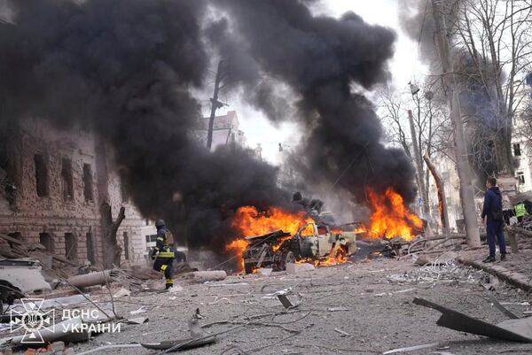 In this photo provided by the Ukrainian Emergency Service, firefighters put out the fire following Russia's missile attack that killed at least 20 civilians in Sumy, Ukraine, Sunday, April 13, 2025. (Ukrainian Emergency Service via AP)