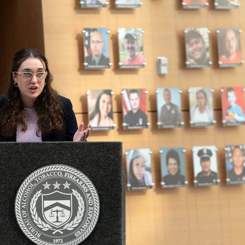 FILE - Survivor of gun violence Mia Tretta speaks while standing next to a wall with photographs of victims of gun violence during the Inaugural Gun Violence Survivors' Summit at ATF Headquarters in Washington, April 23, 2024. (AP Photo/Jose Luis Magana, File)