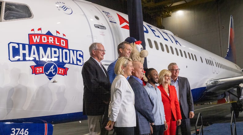 Braves and Delta representatives pose for photographs during a ceremony that revealed the Delta Air Lines jet dedicated to the Braves championship Thursday, July 28, 2022. (Steve Schaefer / steve.schaefer@ajc.com)