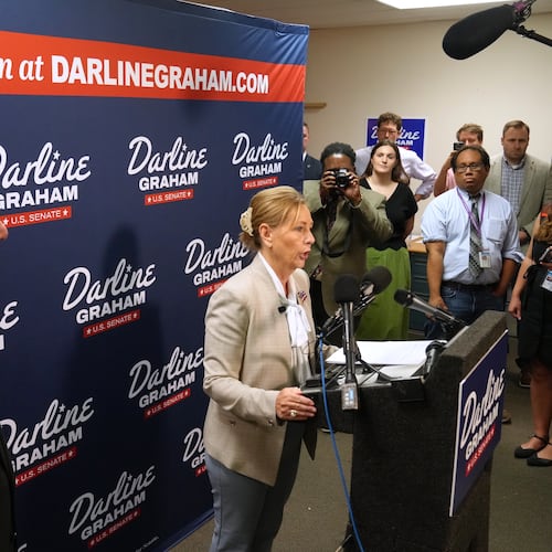 Gov. Henry McMaster, R-S.C., left, looks on as Sen. Darline Graham, R-S.C., speaks at a news conference for her campaign a day ahead of the special GOP Senate runoff to replace her brother, the late Sen. Lindsey Graham, R-S.C., Monday, Aug. 24, 2026, in Columbia, S.C. (AP Photo/Meg Kinnard)