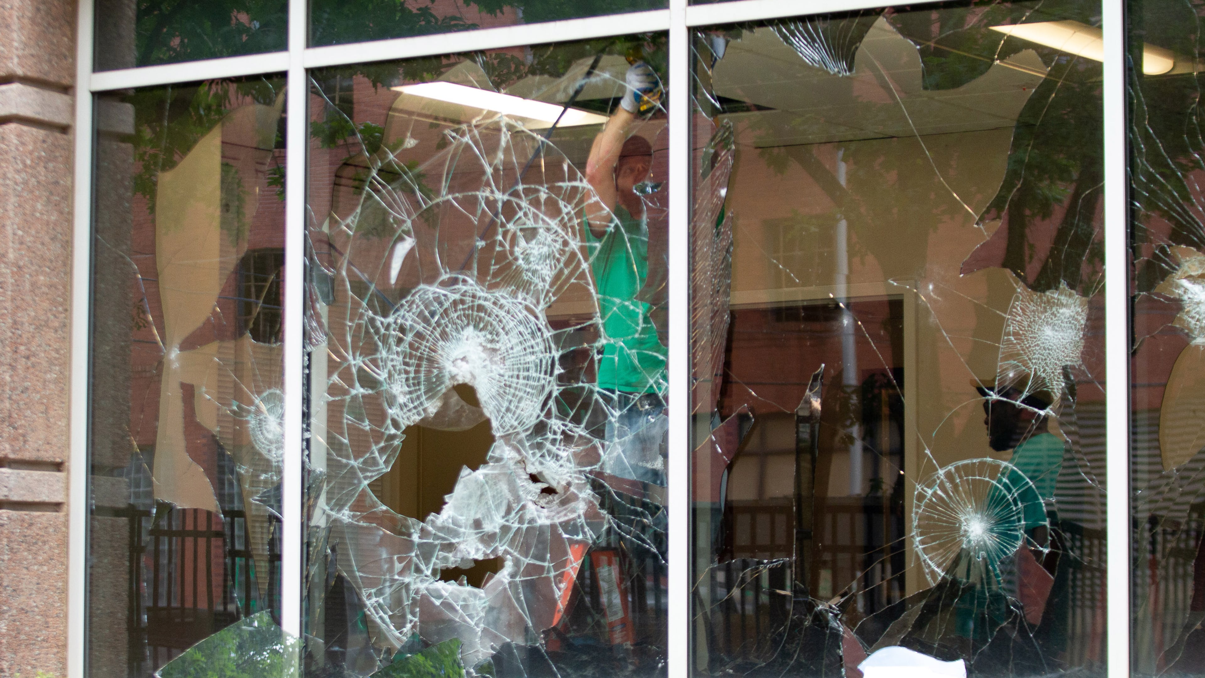 Workers made repairs to the Immigration and Customs Enforcement field office in Atlanta on July 26, 2020, after vandalism at the facility. (Steve Schaefer/AJC)