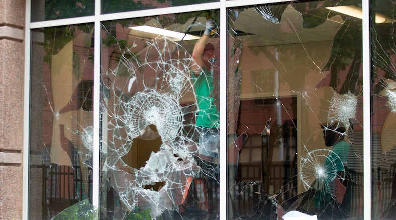 Workers make repairs to the DHS/ICE field office in Atlanta on Sunday, July 26, 2020.  STEVE SCHAEFER FOR THE ATLANTA JOURNAL-CONSTITUTION