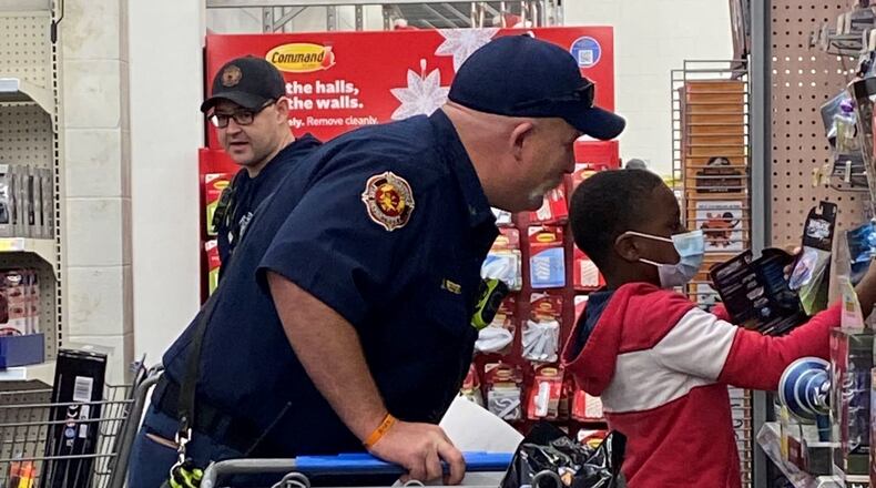 About 125 children from Woodstock had a merrier Christmas with presents bought for them by Woodstock police and fire personnel with $13,000 from the Woodstock Public Safety Foundation. (Courtesy of the Woodstock Public Safety Foundation)
