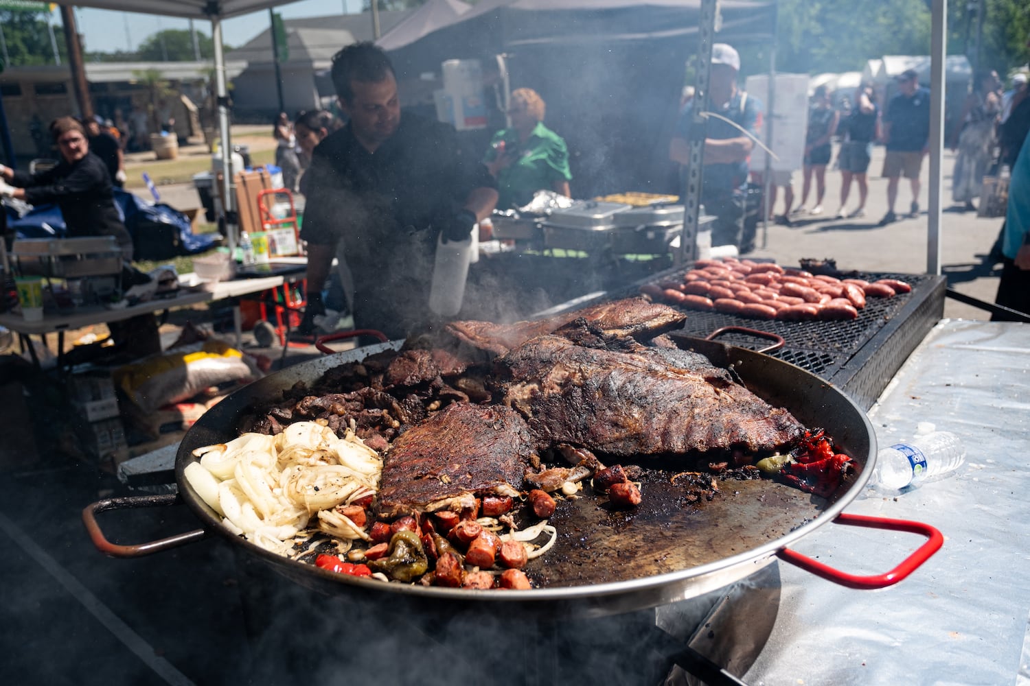 Food cooks at a booth at the Atlanta Dogwood Festival at Piedmont Park on Saturday, April 11, 2026. (Ben Gray for the AJC)
