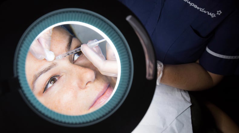 A patient receives a treatment that will include anti-wrinkle and skin rejuvenation aesthetic treatments such as BOTOX and Juvederm dermal fillers. AP File Photo.