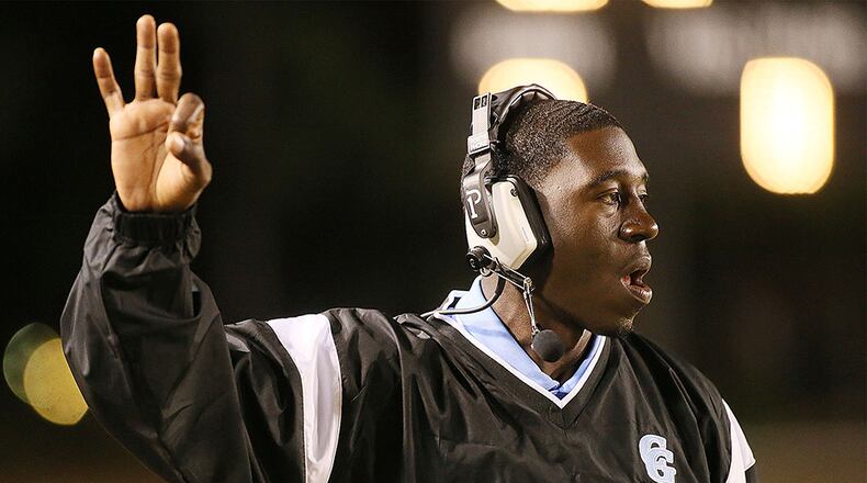 Cedar Grove's head coach Jermaine Smith signals his players. (Phil Skinner/Special to AJC)