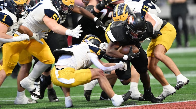 Hebron Christian quarterback Thomas Stallworth (16) gets tackled by Prince Avenue Christian's Luke Darling (left) and Prince Avenue Christian's Gaines Scoggins (13) during the first half of the GHSA Class 3A-A private championship game at Mercedes-Benz Stadium in December, 2024. The Class 3A-A private school division was created in 2024 after private schools won 73 of the 152 state championships contested in Class 3A and below during the previous two academic years.(Hyosub Shin / AJC)