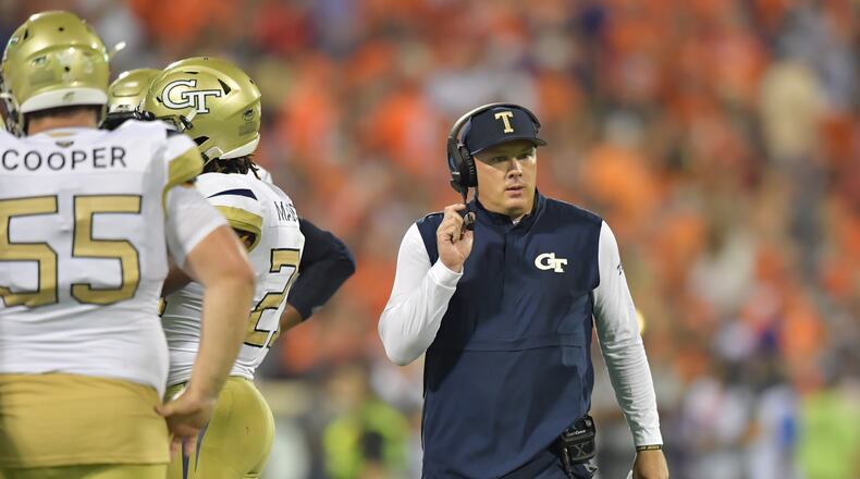 Georgia Tech head coach Geoff Collins communicates with radio device in the first half at Memorial Stadium on the Clemson University campus in Clemson, S.C. on Thursday, August 29, 2019. Georgia Tech took the field for the first time with Geoff Collins as head coach. (Hyosub Shin / Hyosub.Shin@ajc.com)
