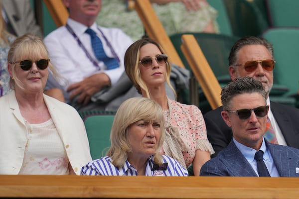 Actor Sarah Lancashire, Deborah Jevans, Britney Theriot, golfer Justin Rose and actor Russell Crowe, from left, sit in the Royal Box on Centre Court on day two at the Wimbledon Tennis Championships in London, Tuesday, July 1, 2025. (AP Photo/Kin Cheung)