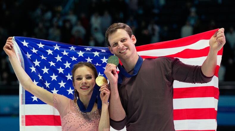 Gold medalists Alisa Efimova and Misha Mitrofanov of the United States celebrate with their national flag and medals after the Pairs Free Skating of the ISU Four Continents Figure Skating Championships in Beijing, China, Saturday, Jan. 24, 2026. (AP Photo/Vincent Thian)