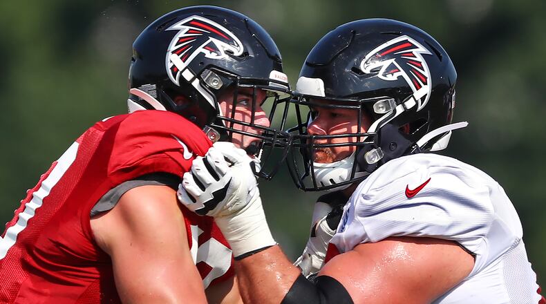 Falcons defensive end John Cominsky (left) rushes against tackle Jake Matthews during team practice Monday, July 29, 2019, in Flowery Branch.