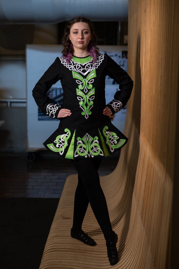 Aisling Mahony, 21, wears a team dance dress from Atlanta Irish Dance by Burke Connolly at Georgia Tech College of Design in Atlanta, where she attends college. (Arvin Temkar/AJC)