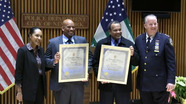 Axel and Kenny Dodson, retired New York Police Department officers, were presented with the Outstanding Citizens Award for their quick actions to detain a woman accused of trying to burn down Martin Luther King Jr.'s birth home in Atlanta on Thursday.