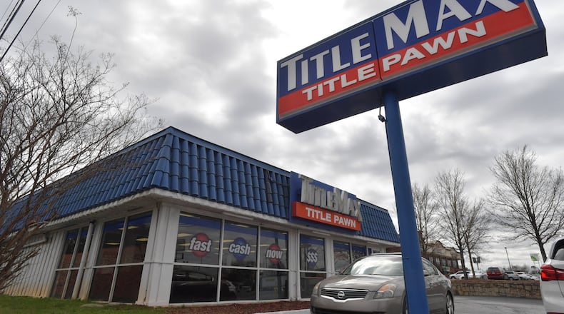 The Consumer Financial Protection Bureau wants to scrap a rule that would have required payday loan and vehicle title companies, such as this TitleMax in Doraville, to assess whether consumers can afford loans. The rule, which was to take effect later this year, was intended to protect consumers trapped in a cycle of loans with exorbitant interest rates. HYOSUB SHIN / HSHIN@AJC.COM