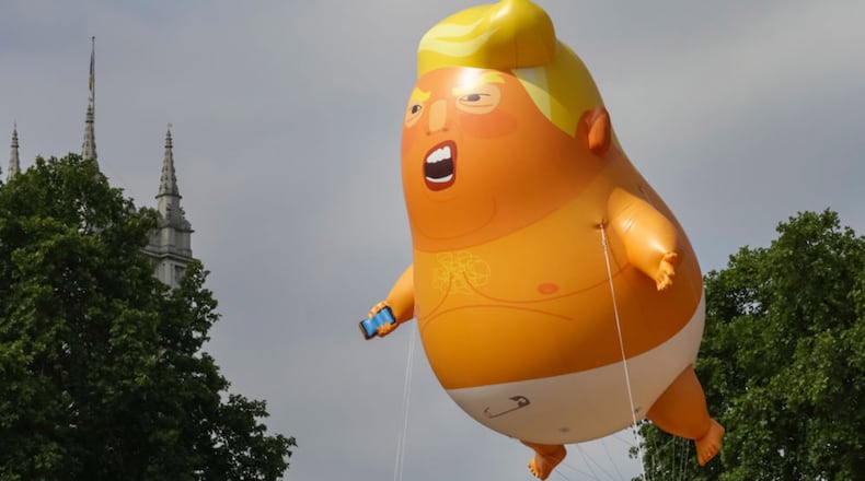 A giant baby trump balloon flies over the Parliament Square during a demonstration against the visit to the UK by US President Donald Trump on July 13, 2018 in London, England.