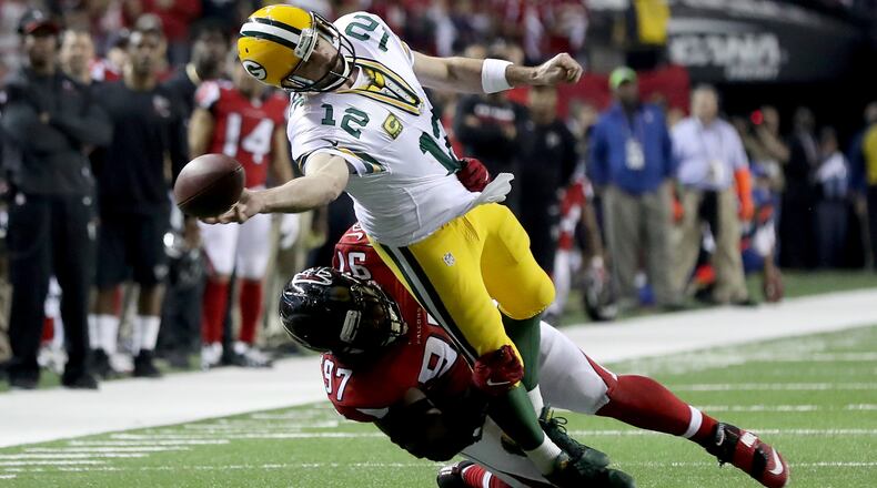 Grady Jarrett of the Falcons tries to pull down Packers QB Aaron Rodgers in the NFC Championship Game at the Georgia Dome.  (Photo by Rob Carr/Getty Images)