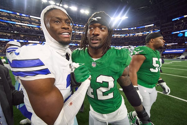 Dallas Cowboys wide receiver George Pickens, left, talks with Philadelphia Eagles linebacker Smael Mondon Jr. during an NFL football game between the Dallas Cowboys and the Philadelphia Eagles Sunday, Nov. 23, 2025, in Arlington, Texas. (AP Photo/Julio Cortez)