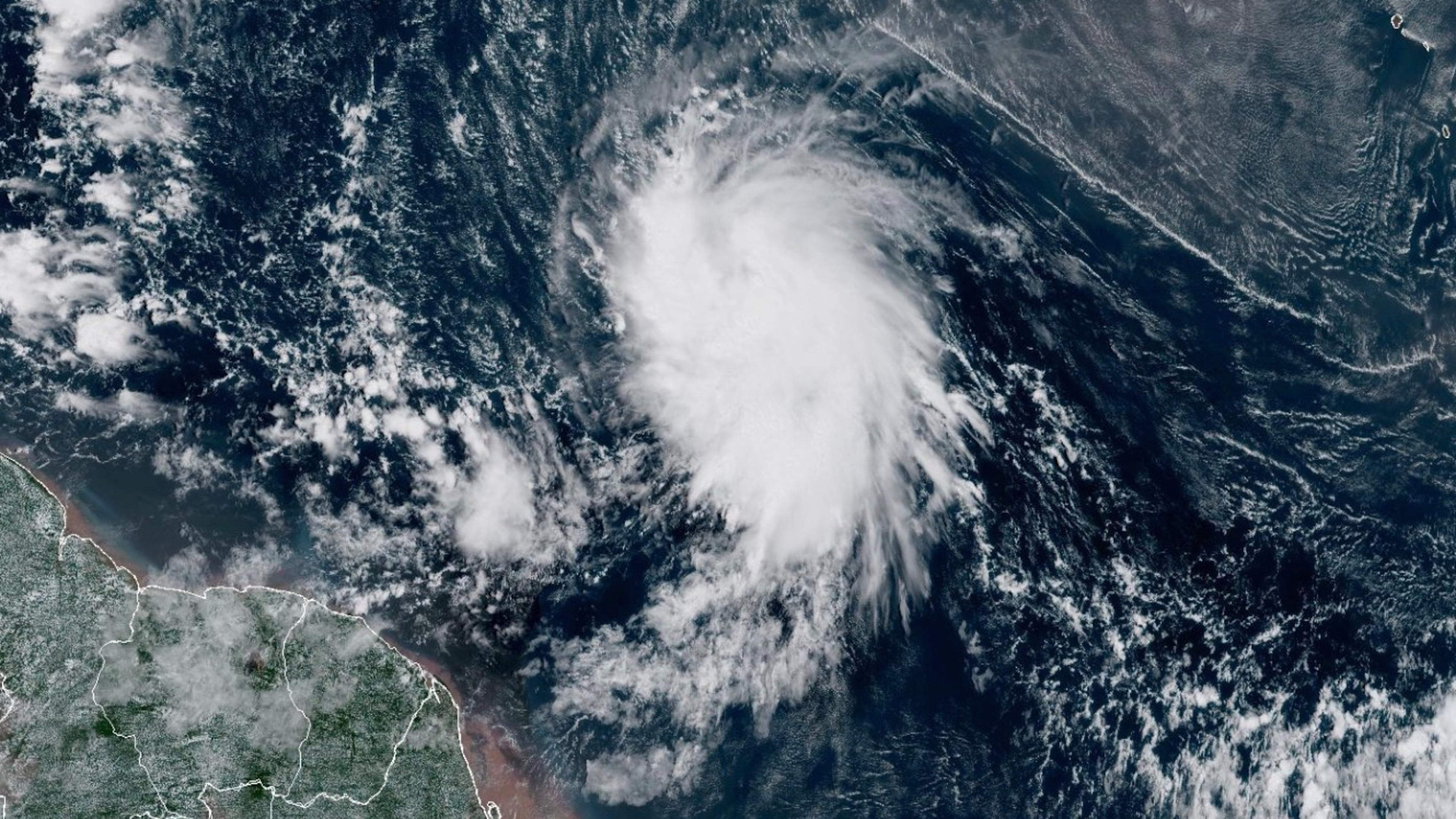 This satellite image provided by the National Oceanic and Atmospheric Administration (NOAA) shows Tropical Storm Jerry in the Atlantic Ocean, Tuesday, Oct. 7, 2025. (NOAA via AP)