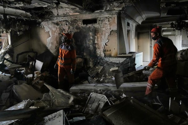 Workers clear rubble of a damaged building, in Tehran, Iran, Wednesday, June 25, 2025, after an Israeli strike on early Tuesday. (AP Photo/Vahid Salemi)