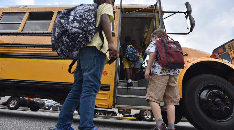 Students board a bus at Burnette Elementary School in Suwanee on Tuesday, August 13, 2019. (Hyosub Shin / Hyosub.Shin@ajc.com)