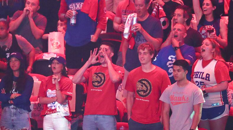 A pair of Atlanta Hawks fans cheer for their team amid a sea of Philadelphia fans at the opening of Game 7 of the Eastern Conference semifinals Sunday, June 20, 2021, in Philadelphia. (Curtis Compton / Curtis.Compton@ajc.com)