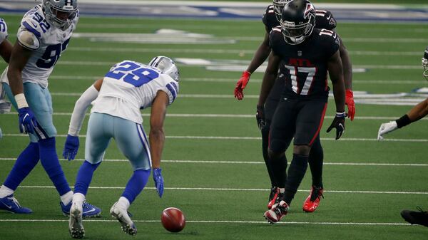Falcons wide receiver Olamide Zaccheaus (17)  watches the onside kick roll before Dallas cornerback C.J. Goodwin (29) dives on the ball to recover the ball for the Cowboys in the closing minutes Sunday, Sept. 20, 2020, in Arlington, Texas. The recovery led the Dallas' 40-39 victory over Atlanta. (Ron Jenkins/AP)