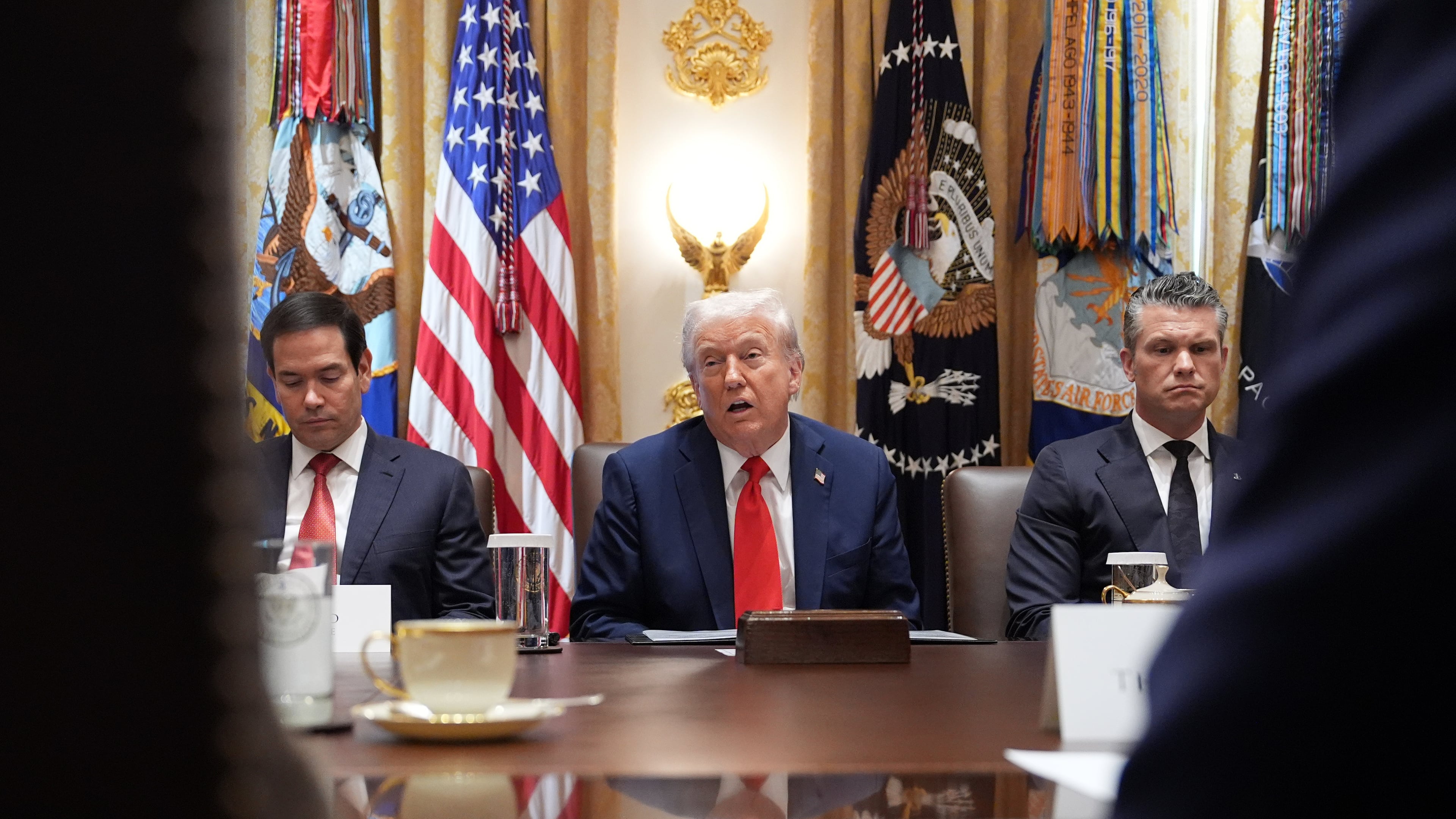 President Donald Trump speaks during a cabinet meeting at the White House, Thursday, Oct. 9, 2025, in Washington, as Secretary of State Marco Rubio, left, and Defense Secretary Pete Hegseth, right, look on. (AP Photo/Evan Vucci)