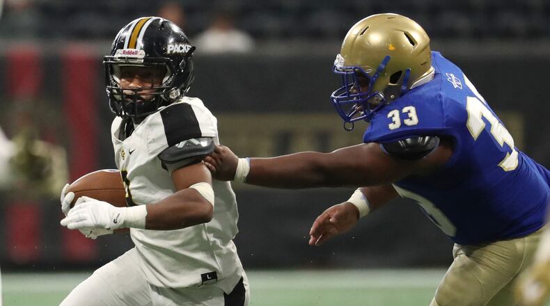 Colquitt County running back Daijun Edwards (3) runs past McEachern linebacker Myles Henderson (33) in the second half of the Corky Kell Classic game Saturday, Aug. 18, 2018 at Mercedes-Benz Stadium in Atlanta.