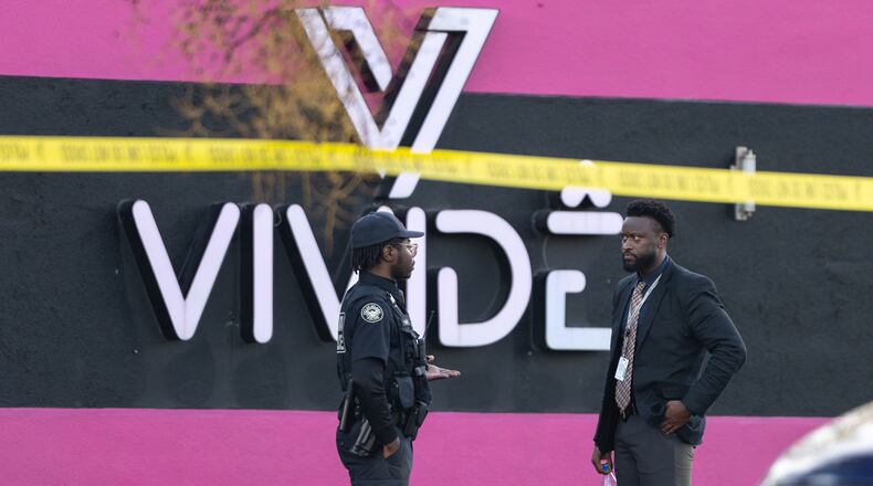 An Atlanta police officer and detective stand in the parking lot of the Vivide nightclub on Marietta Boulevard following a fatal stabbing early Wednesday, Nov. 26, 2025, in Blandtown. (Ben Hendren for the AJC)