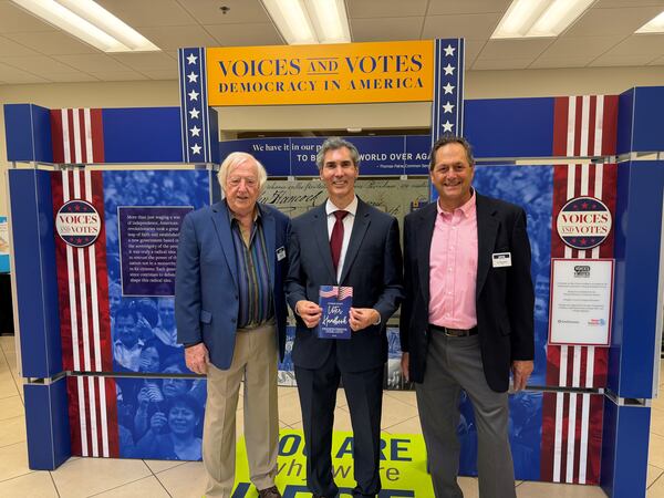 AJC Opinion Editor David Plazas (center) stands with Georgia Writers Museum board member Chip Bell (left) and board president Lou Benjamin at the inaugural “Voices and Votes: Democracy in America” exhibit on Saturday, April 25, 2026, in Eatonton. (David Plazas/AJC)
