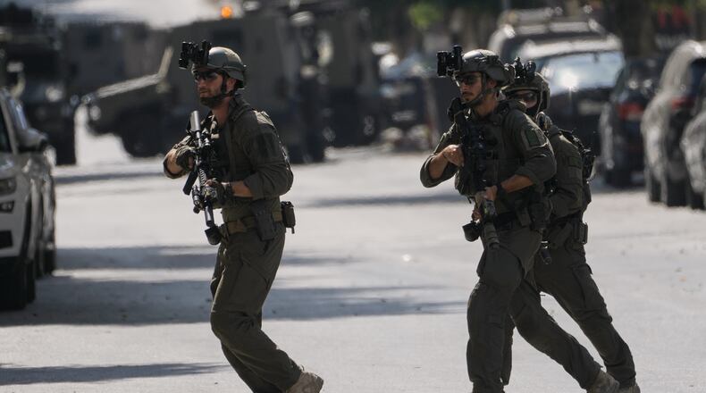 Israeli soldiers move on a street outside the Nablus Speciality Hospital in the West Bank city of Nablus, Friday, July 24, 2026, after Israeli military killed, according to health authorities, at least four Palestinians in the village of Tell in the northern West Bank. (AP Photo/Majdi Mohammed)
