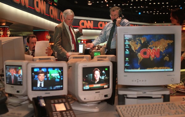 Ted Turner (left), vice chairman of Time-Warner Inc., and Tom Johnson, president, chairman and CEO of the CNN News Group, confer during coverage of Operation Desert Fox in Iraq in 1998. (Jean Shifrin/AJC)