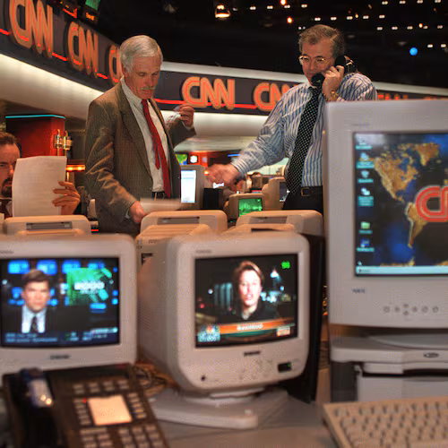 Ted Turner (left), vice chairman of Time-Warner Inc., and Tom Johnson, president, chairman and CEO of The CNN News Group, confer during coverage of Operation Desert Fox in Iraq. (Jean Shifrin/AJC 1998)