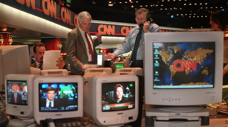 Ted Turner (left), vice chairman of Time-Warner Inc., and Tom Johnson, president, chairman and CEO of The CNN News Group, confer during coverage of Operation Desert Fox in Iraq. (Jean Shifrin/AJC 1998)